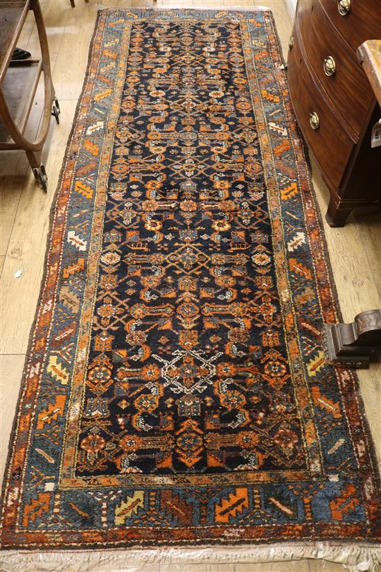 A Caucasian black ground hall carpet 294 x 105cm